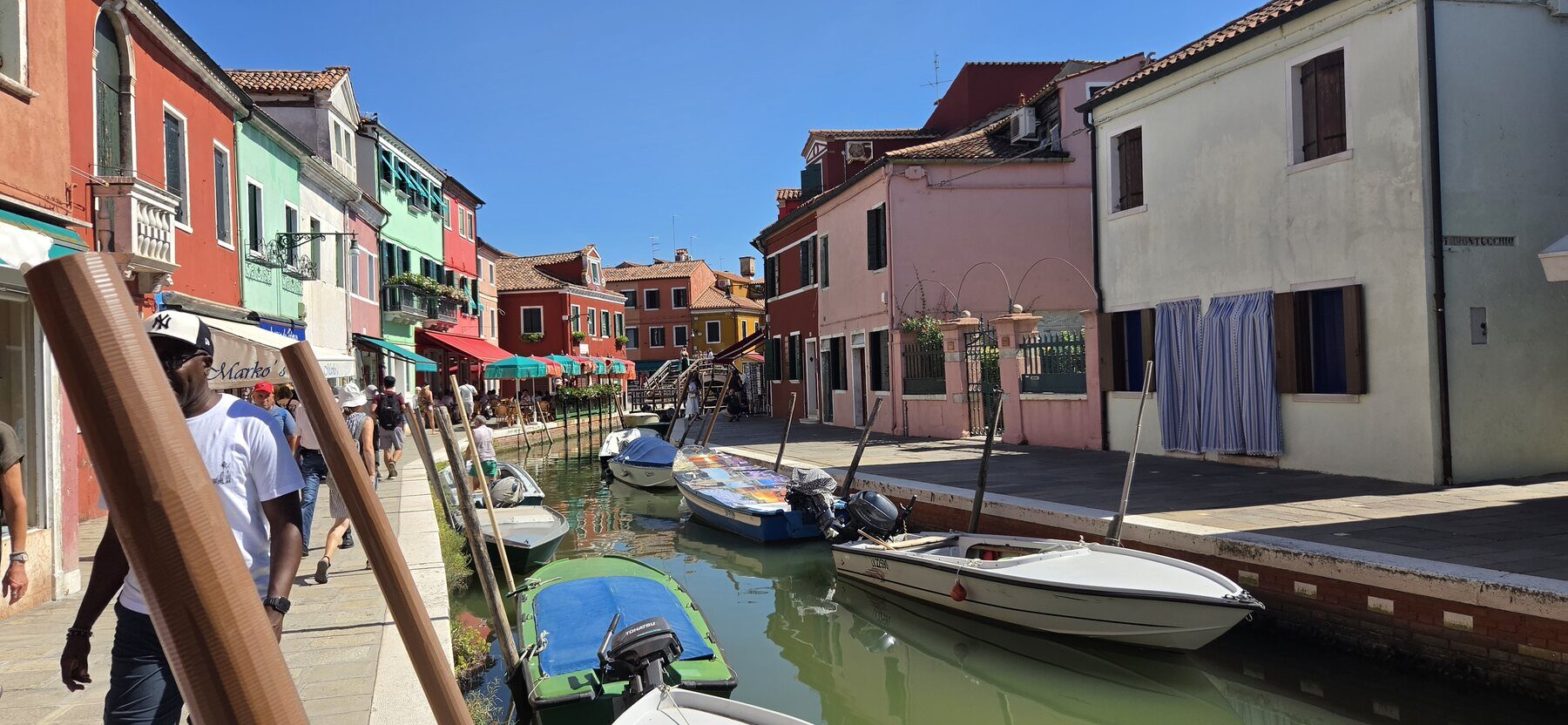 A colorful canal lined with houses in Burano
